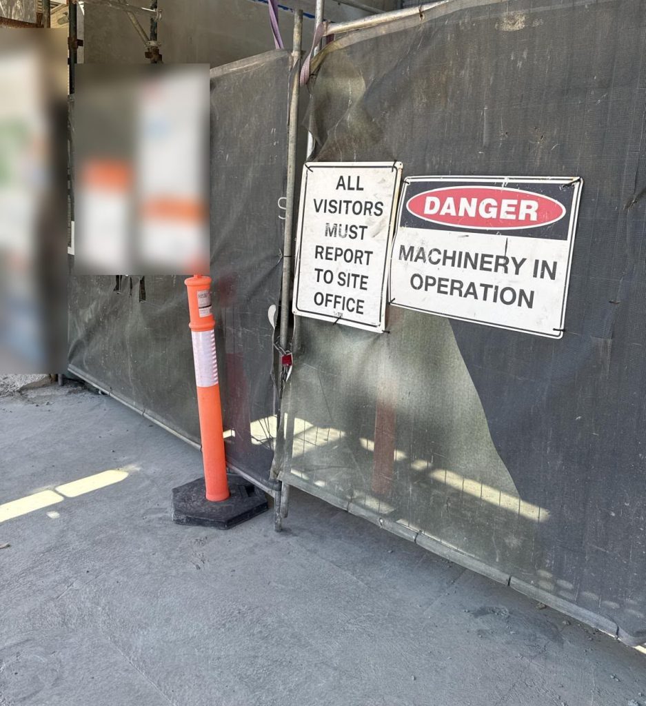 Construction site gate with safety signs on a Central Coast building site