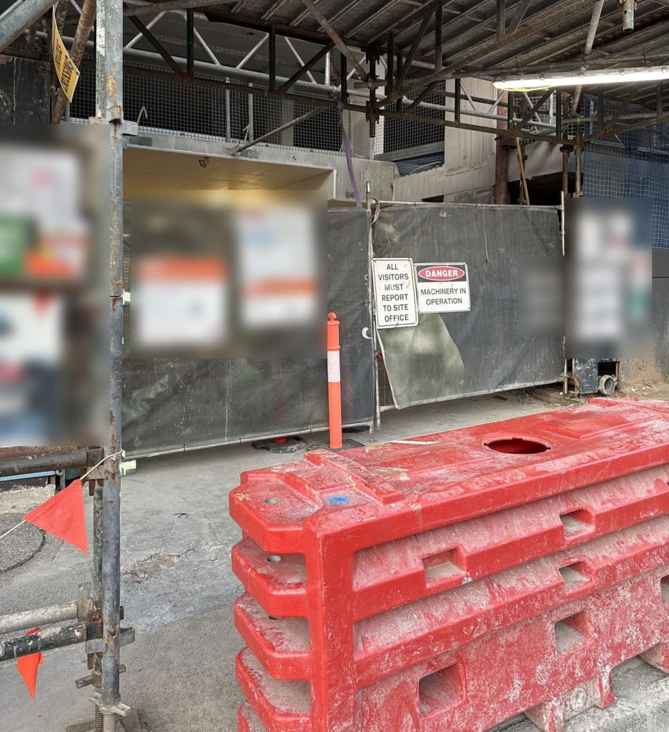 Construction site hoarding and water-filled barriers